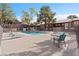 Inviting community pool surrounded by lounge chairs and lush landscaping on a bright day at 2750 S Durango Dr # 2061, Las Vegas, NV 89117