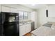 Efficient kitchen layout with granite countertops, white cabinets, and standard appliances at 2750 S Durango Dr # 2061, Las Vegas, NV 89117