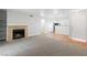 Bright living room featuring a cozy fireplace, neutral walls, and a mix of carpet and hardwood flooring at 2750 S Durango Dr # 2061, Las Vegas, NV 89117