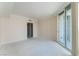 Cozy bedroom with neutral carpet, sliding glass doors to balcony, and en-suite bath access at 2877 Paradise Rd # 1806, Las Vegas, NV 89109