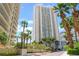 Luxury high-rise building with modern architecture, surrounded by lush greenery, showcasing upscale living at 2877 Paradise Rd # 1806, Las Vegas, NV 89109