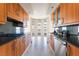 Modern kitchen featuring wood cabinetry, dark countertops, stainless steel appliances, and marble flooring at 2877 Paradise Rd # 1806, Las Vegas, NV 89109