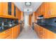 Contemporary kitchen featuring wood cabinets, stainless steel appliances, and granite countertops at 2877 Paradise Rd # 1806, Las Vegas, NV 89109