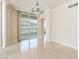 Bright living room with tile floors, base molding, and sliding glass door to balcony at 2877 Paradise Rd # 1806, Las Vegas, NV 89109
