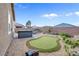 This backyard features a putting green, patio, hot tub, and exterior seating at 2924 Duverney Ave, Henderson, NV 89044