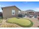 The backyard features a putting green, hot tub, and patio with exterior seating at 2924 Duverney Ave, Henderson, NV 89044