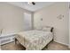 Neutral bedroom with a ceiling fan, window with blinds, and decorative wall art at 2924 Duverney Ave, Henderson, NV 89044