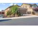 Attractive single-level home with a two-car garage, complemented by lush shrubs and a well-maintained yard at 2924 Duverney Ave, Henderson, NV 89044