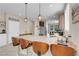 Bright kitchen view of island with granite counters, barstool seating, and modern pendant lighting at 2924 Duverney Ave, Henderson, NV 89044