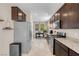 Spacious kitchen with stainless steel appliances and granite countertops with view to the living area at 2924 Duverney Ave, Henderson, NV 89044