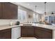 Granite countertops in kitchen showing cabinetry and breakfast bar with view to sitting area and exterior patio at 2924 Duverney Ave, Henderson, NV 89044