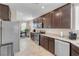 Open-concept kitchen featuring stainless steel appliances, granite countertops and dark cabinets at 2924 Duverney Ave, Henderson, NV 89044
