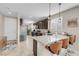 Well-lit kitchen showcasing a large island with barstools, granite counters and stainless steel appliances at 2924 Duverney Ave, Henderson, NV 89044