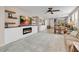 Open-concept living area with a cozy fireplace, tile floors, and abundant natural light at 2924 Duverney Ave, Henderson, NV 89044