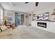 Cozy living room with a fireplace, patio access, and open sightlines to the dining room and kitchen at 2924 Duverney Ave, Henderson, NV 89044