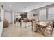 Open-concept living room and kitchen area with tile flooring and natural light through the windows at 2924 Duverney Ave, Henderson, NV 89044