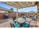 Stylish outdoor patio with a pergola, seating, and a barbecue grill at 2924 Duverney Ave, Henderson, NV 89044