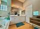 Bright bathroom with dual sinks, large mirror, and natural light from glass block window at 2986 Matese Dr, Henderson, NV 89052