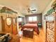 Unique bedroom with hardwood floors, colorful bedding, vintage decor, and a mirrored closet at 2986 Matese Dr, Henderson, NV 89052
