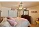 Inviting bedroom features soft bedding, warm lighting, and a ceiling fan for added comfort at 2986 Matese Dr, Henderson, NV 89052