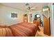 Bedroom with hardwood floors, striped bedding, a ceiling fan, and vintage-style furnishings at 2986 Matese Dr, Henderson, NV 89052