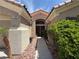 Inviting front entrance with double doors, desert landscaping, and a well-lit pathway for a warm welcome at 2986 Matese Dr, Henderson, NV 89052