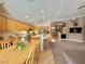 Modern kitchen with stainless steel appliances, an island with bar seating, and seamless flow to the living area at 2986 Matese Dr, Henderson, NV 89052
