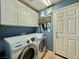Laundry room featuring a modern washer and dryer set and white cabinets at 2986 Matese Dr, Henderson, NV 89052