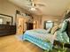 Well-lit main bedroom showcasing light wood floors, a ceiling fan, and tranquil decor at 2986 Matese Dr, Henderson, NV 89052