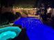 Inviting backyard pool and spa with waterfall feature and ambient string lights for evening relaxation at 2986 Matese Dr, Henderson, NV 89052