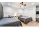 Bedroom featuring two beds, a ceiling fan, closet, and shelves with gray wood floors at 3120 S Eastern Ave # 5, Las Vegas, NV 89169