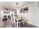 A dining room featuring a wood table, white chairs, modern lighting, and gray wood floors at 3120 S Eastern Ave # 5, Las Vegas, NV 89169