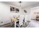 A dining room featuring a wood table, white chairs, modern lighting, and gray wood floors at 3120 S Eastern Ave # 5, Las Vegas, NV 89169