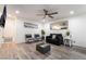 Bright living room features a ceiling fan, TV, and wood-style flooring at 3120 S Eastern Ave # 5, Las Vegas, NV 89169