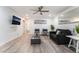 Bright living room features a ceiling fan, TV, and wood-style flooring at 3120 S Eastern Ave # 5, Las Vegas, NV 89169
