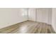 Bright bedroom with wood floors, closet, and window with blinds at 3151 Soaring Gulls Dr # 2002, Las Vegas, NV 89128