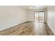 Spacious bedroom featuring wood-look floors and a sliding door to a balcony at 3151 Soaring Gulls Dr # 2002, Las Vegas, NV 89128