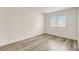 Well-lit bedroom features wood-look flooring, a large window, and ample space at 3151 Soaring Gulls Dr # 2002, Las Vegas, NV 89128