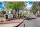 Community entrance with Desert Shores Villas Condominiums signage, beautiful landscaping, and controlled access at 3151 Soaring Gulls Dr # 2002, Las Vegas, NV 89128