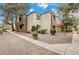Condominium exterior with well-maintained landscaping and a neutral color palette on a bright, sunny day at 3151 Soaring Gulls Dr # 2002, Las Vegas, NV 89128
