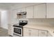 Kitchen with white cabinetry, stainless appliances and countertops, and wood-look floors at 3151 Soaring Gulls Dr # 2002, Las Vegas, NV 89128