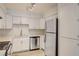 Clean kitchen with white cabinets, stainless steel appliances, and wood-look flooring at 3151 Soaring Gulls Dr # 2002, Las Vegas, NV 89128