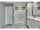 Bright bathroom with a glass door shower, tiled floors, and a dual sink vanity at 3166 Via Da Vinci, Henderson, NV 89044