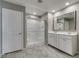 Bathroom showcasing a glass door shower, tiled floors, and a double sink vanity at 3166 Via Da Vinci, Henderson, NV 89044