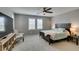 Comfortable bedroom with ceiling fan, two windows, and a well-lit bedside at 3166 Via Da Vinci, Henderson, NV 89044