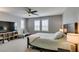 Spacious bedroom with a ceiling fan, two windows, and a comfortable bed at 3166 Via Da Vinci, Henderson, NV 89044