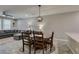 Open-concept dining area featuring a wood table and chairs, seamlessly connected to the living room at 3166 Via Da Vinci, Henderson, NV 89044