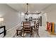 An eat-in kitchen features a wood dining table with modern chandelier at 3166 Via Da Vinci, Henderson, NV 89044