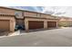 Street view of townhomes featuring attached garages and well-maintained landscaping at 3166 Via Da Vinci, Henderson, NV 89044