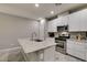 Well-equipped kitchen features a center island with sink, stainless steel appliances, and white cabinetry at 3166 Via Da Vinci, Henderson, NV 89044